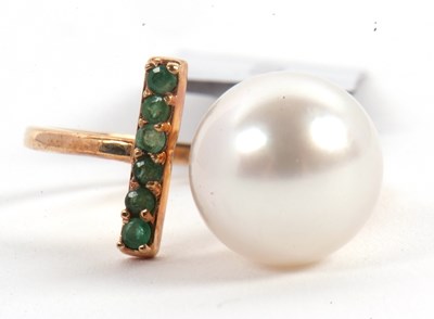 Lot 57 - A 9ct cultured pearl and emerald ring, the...