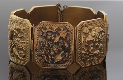 Lot 335 - Yellow metal panelled bracelet, the seven...