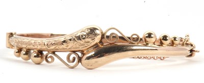 Lot 121 - A gold bangle, the hinged crossover style...