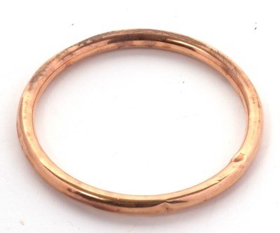 Lot 180 - A 9ct gold bangle, the hollow bangle stamped...