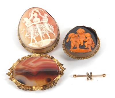 Lot 241 - Four brooches: to include an oval agate in...