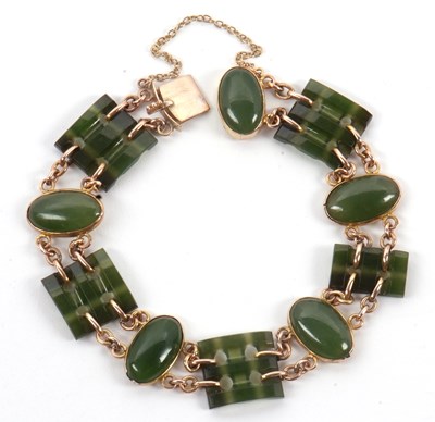Lot 130 - A jade bracelet, set with alternating pierced...