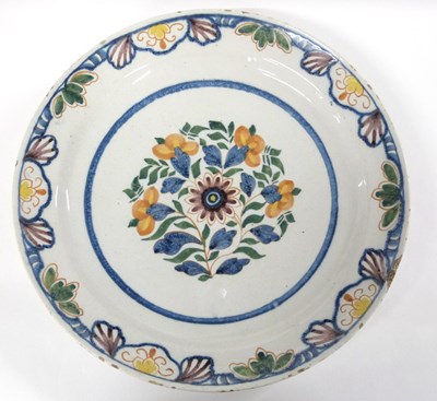 Lot 260 - An 18th Century delft charger with floral...