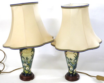 Lot 281 - Pair of Moorcroft lamp bases with shades, the...