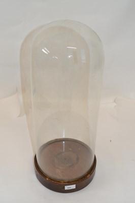 Lot 455 - A clear glass dome on a turned wooden socle...