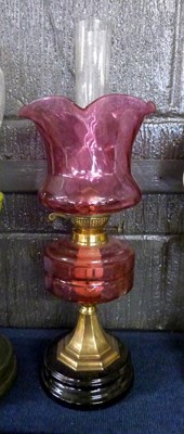 Lot 290 - An oil lamp with cranberry reservoir and shade