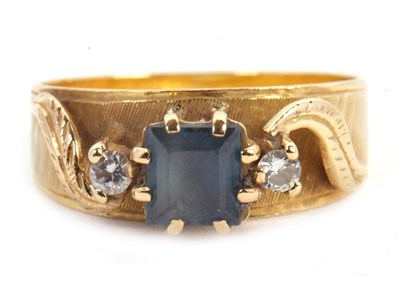 Lot 51 - A sapphire and diamond ring, the central...