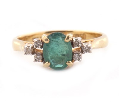 Lot 35 - An emerald and diamond ring, the central oval...