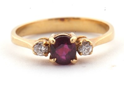 Lot 36 - A ruby and diamond ring, the round ruby set to...