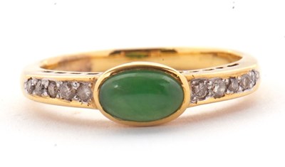 Lot 30 - A jade and diamond ring, the oval collet...
