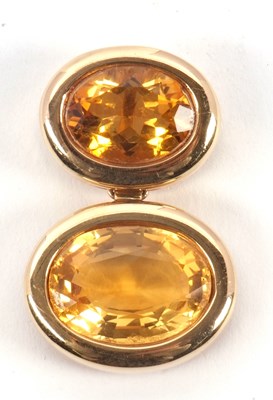 Lot 117 - A two stone citrine pendant, the slightly...