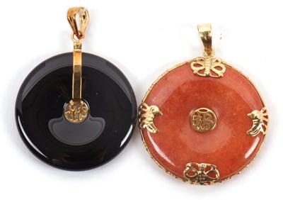 Lot 129 - Two Chinese bi style pendants, one in black...