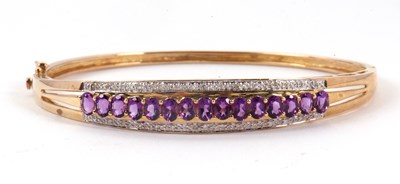 Lot 145 - A 9ct amethyst and diamond bangle, the upper...