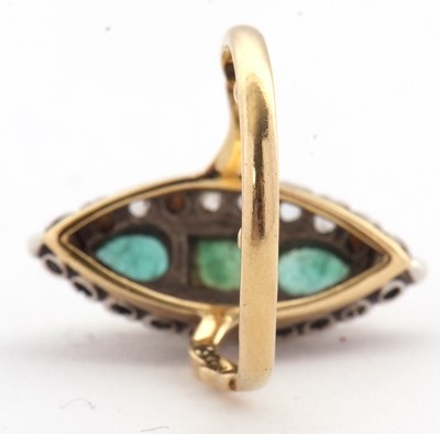 Lot 21 - A marquise shape emerald and diamond ring, set...