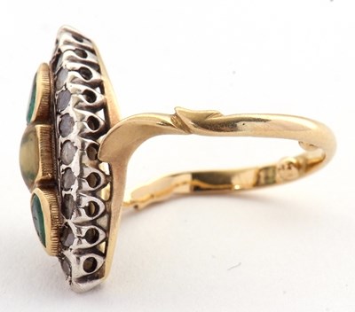Lot 21 - A marquise shape emerald and diamond ring, set...