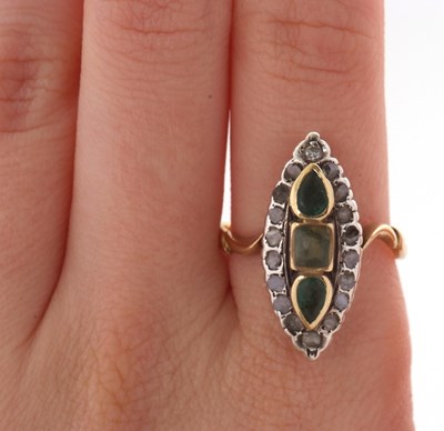 Lot 21 - A marquise shape emerald and diamond ring, set...
