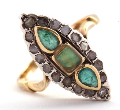 Lot 21 - A marquise shape emerald and diamond ring, set...