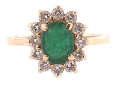Lot 25 - An emerald and diamond cluster ring, set with...