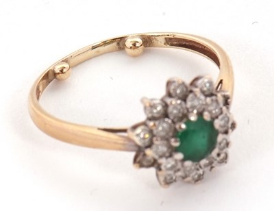 Lot 22 - An emerald and diamond cluster ring, set with...