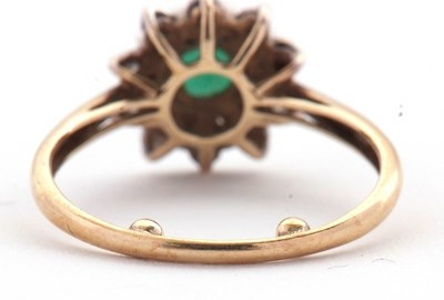 Lot 22 - An emerald and diamond cluster ring, set with...