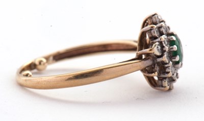 Lot 22 - An emerald and diamond cluster ring, set with...