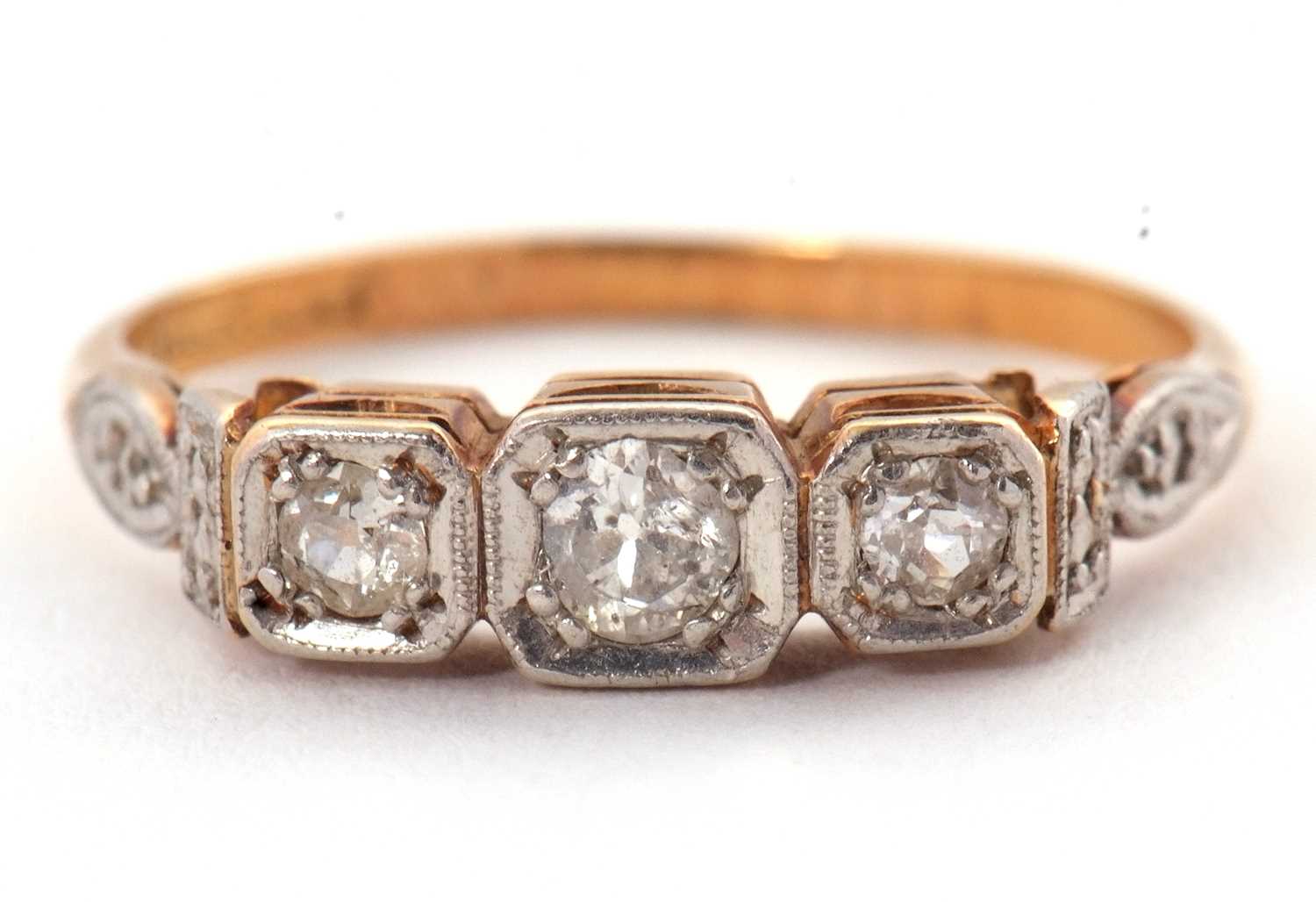 Lot 17 - A three stone diamond ring, the three slightly...