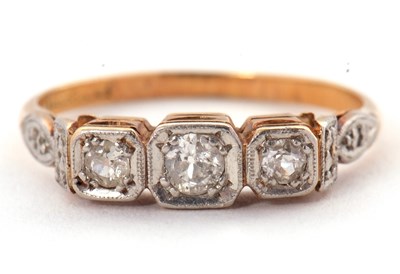 Lot 17 - A three stone diamond ring, the three slightly...