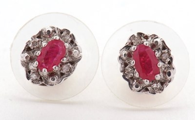Lot 91 - A pair of ruby and diamond cluster earrings,...
