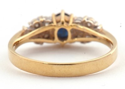 Lot 11 - An 18ct sapphire and diamond ring, the central...