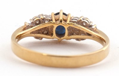 Lot 11 - An 18ct sapphire and diamond ring, the central...