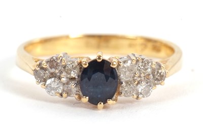 Lot 11 - An 18ct sapphire and diamond ring, the central...