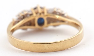 Lot 11 - An 18ct sapphire and diamond ring, the central...