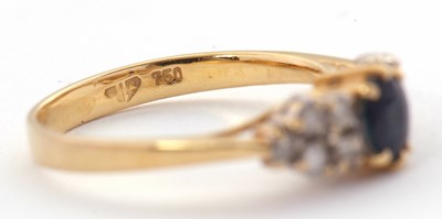 Lot 11 - An 18ct sapphire and diamond ring, the central...