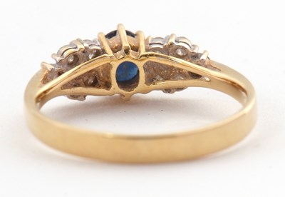 Lot 11 - An 18ct sapphire and diamond ring, the central...