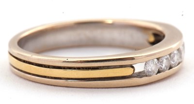 Lot 31 - A seven stone diamond ring, with channel set...