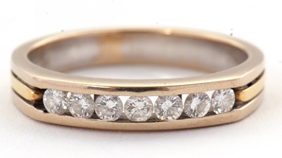 Lot 31 - A seven stone diamond ring, with channel set...