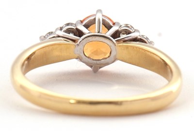 Lot 29 - An 18ct orange stone and diamond ring, the...
