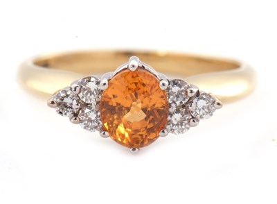 Lot 29 - An 18ct orange stone and diamond ring, the...