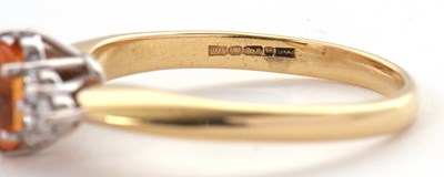 Lot 29 - An 18ct orange stone and diamond ring, the...