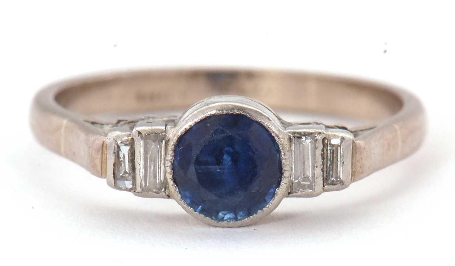 Lot 66 - An 18ct and platinum sapphire and diamond ring,...