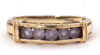 Lot 60 - A 9ct gemset ring, with channel set pale...