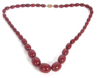 Lot 203 - A bakelite 'cherry amber' necklace, the...
