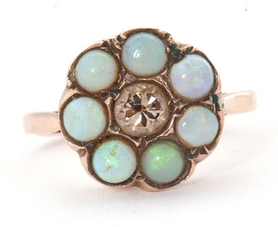 Lot 71 - An opal and diamond ring, the central round...