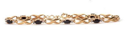 Lot 164 - A sapphire and diamond bracelet, set with oval...