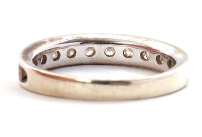 Lot 45 - A 9ct diamond ring, with channel set round...