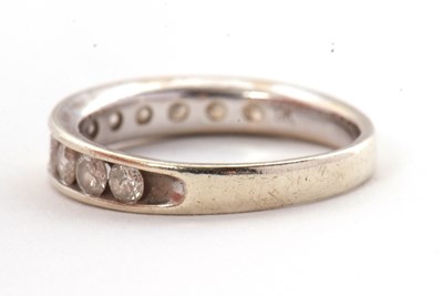 Lot 45 - A 9ct diamond ring, with channel set round...
