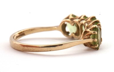 Lot 46 - A 9ct peridot ring, the five oval peridots...