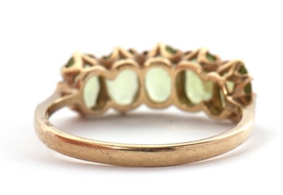 Lot 46 - A 9ct peridot ring, the five oval peridots...