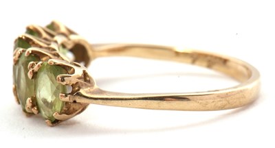 Lot 46 - A 9ct peridot ring, the five oval peridots...