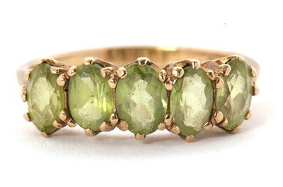 Lot 46 - A 9ct peridot ring, the five oval peridots...